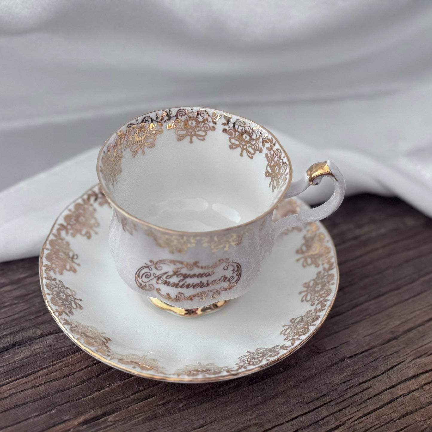 Paragon 'Joyeux Anniversaire' Golden Floral Pattern Teacup and Saucer